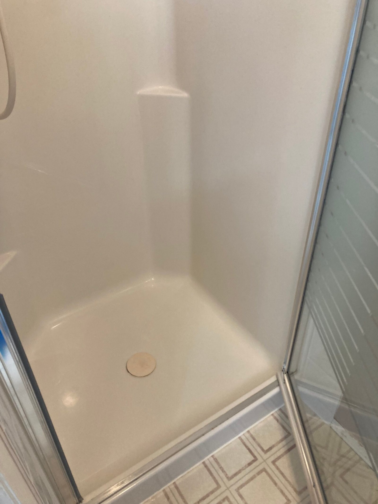 Shower base and lower walls after cleaning.