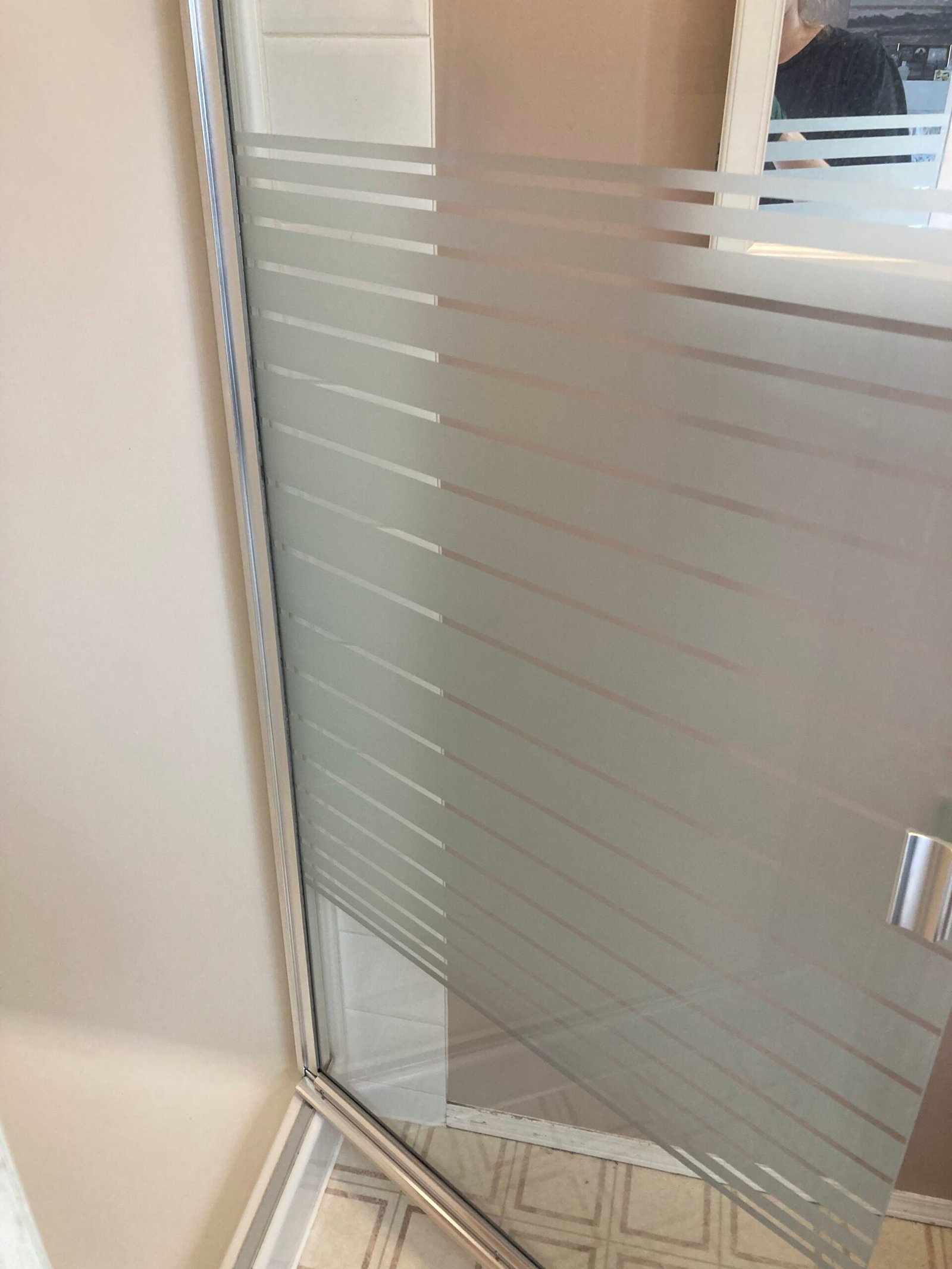 Striped glass shower door after cleaning.
